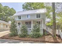 Charming two-story home with a metal roof, inviting front porch, and well-manicured landscaping at 918 Orient St, Durham, NC 27701
