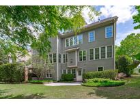 View of the backyard with a patio and well-maintained landscaping that enhances the property's appeal at 103 Woodland Ridge Ct, Cary, NC 27519