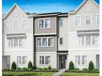 Charming townhome featuring modern architectural details and a well-manicured front lawn at 1043 Zelkova Ln, Chapel Hill, NC 27517