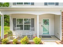 Charming front porch with rocking chairs and a welcoming teal door at 1305 Montreux Ct, Mebane, NC 27302