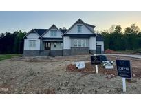 Beautiful two-story home with light siding, stone accents, and a striking front entrance at 1403 Cottondale Lane, Wake Forest, NC 27587