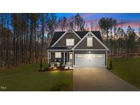 Charming two-story home with symmetrical roofline, white trim, and two car garage at 145 Leisure Ln # 12, Louisburg, NC 27549