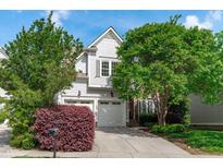 Charming home with a two-car garage, mature trees, and a well-manicured lawn at 2832 Cameron Pond Dr, Cary, NC 27519