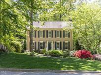 Charming two-story home with a well-manicured lawn and mature trees at 315 King George Loop, Cary, NC 27511