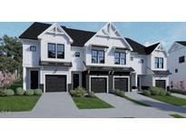Modern townhome exterior with white siding, black accents, and attached garages, offering stylish curb appeal at 3922 Lost Fawn Ct, Raleigh, NC 27612