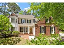 Charming two-story home with a brick and siding exterior, complemented by a well-manicured front yard at 4012 Graham Newton Rd, Raleigh, NC 27606