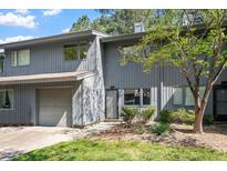 Charming townhome features a gray exterior, attached garage, and mature landscaping at 4318 Hunters Club Dr, Raleigh, NC 27606