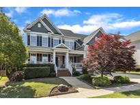 Charming two-story home with landscaped yard, covered porch, and beautiful curb appeal at 602 Alden Bridge Dr, Cary, NC 27519