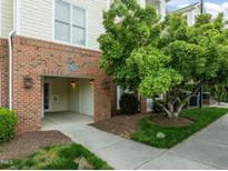 Inviting brick building entrance featuring a covered walkway and well-maintained landscaping at 712 Portstewart Dr, Cary, NC 27519
