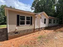 Charming single-story home featuring neutral siding, dark shutters, and a classic brick foundation at 765 Whitley Rd, Middlesex, NC 27557