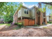 Charming townhome featuring a brick facade, outdoor patio area, and well-maintained landscaping at 497 Summerwalk Cir # 497, Chapel Hill, NC 27517