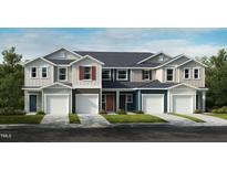 Beautiful new townhomes featuring multiple garage doors, colorful exteriors, and sidewalk-lined street at 1031 Mountain Crown St, Durham, NC 27703