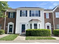 Charming townhouse featuring a well-manicured front lawn and inviting front door at 10943 Pendragon Pl, Raleigh, NC 27614