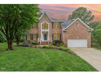 Charming brick home with manicured lawn, mature trees, and inviting front entrance at 111 Murdock Creek Ct, Cary, NC 27519