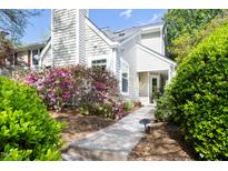 Charming home exterior with lush landscaping, including vibrant azaleas and a welcoming walkway at 111 Sir Richard Ln, Chapel Hill, NC 27517