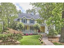 Charming two-story home with a welcoming front porch, landscaped yard, and classic architectural details at 1203 Queensbury Cir, Durham, NC 27713