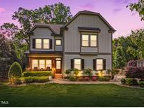Charming two-story home featuring classic architectural details, manicured landscaping, and inviting front porch at 1209 Kingston Ridge Rd, Cary, NC 27511