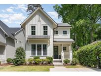 Charming two-story home with white siding, black trim, and a well-manicured lawn at 1422 Banbury Rd, Raleigh, NC 27607