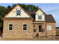 Charming brick home with a classic design featuring a gable roof and large windows at 1611 S Old Carriage Rd, Rocky Mount, NC 27804