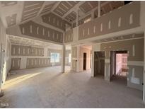 Spacious living room showing drywall installation, high ceilings, and large windows for ample natural light at 1611 S Old Carriage Rd, Rocky Mount, NC 27804