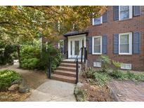 Charming brick home featuring a welcoming front entrance with stairs and mature landscaping at 2607 Buffaloe Rd, Garner, NC 27529