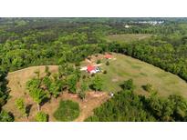 Expansive aerial view showcases a sprawling estate with a pool, surrounded by lush greenery and mature trees at 342 Mcleod Rd, Broadway, NC 27505