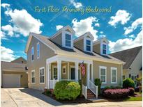 Charming two-story home with dormer windows, a welcoming front porch, and beautifully landscaped front yard at 3827 Heritage Spring Circle Cir, Wake Forest, NC 27587
