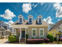 Charming home with dormer windows, a covered porch, and manicured landscaping creates inviting curb appeal at 3827 Heritage Spring Circle Cir, Wake Forest, NC 27587