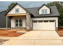 Charming single-Gathering home with a gray exterior, stone accents, and a two-car garage at 40 Wabash St, Pittsboro, NC 27312