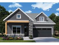 Charming single-Gathering home featuring stone accents, gray siding, and an attached two-car garage at 40 Wabash St, Pittsboro, NC 27312