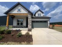Charming single-Gathering home featuring stone accents and a spacious two-car garage at 40 Wabash St, Pittsboro, NC 27312