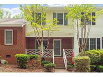 Charming townhouse featuring brick and siding exterior with well-maintained landscaping and inviting entryway at 4617 Fawnbrook Cir, Raleigh, NC 27612