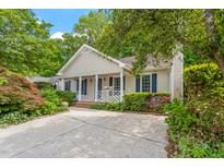 Charming single-story home featuring a well-manicured front yard and cozy front porch area at 5420 Royal Troon Dr, Raleigh, NC 27604