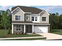 Charming two-story home boasts stone accents, gray siding, a two-car garage, and manicured landscaping at 708 Compeer Way # 27, Rolesville, NC 27571