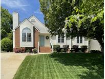 Charming home featuring a well-manicured lawn, inviting entryway, and blossoming landscaping at 9404 Dawnshire Rd, Raleigh, NC 27615