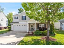 Charming two-story home featuring a well-manicured lawn, brick accents, and an attached two-car garage at 1230 Sunday Silence Dr, Knightdale, NC 27545