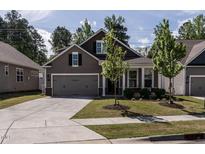 Charming home featuring a two-car garage, well-maintained lawn, and beautiful curb appeal at 1242 Underbrush Dr, Durham, NC 27703