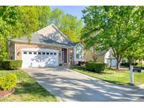 Charming single-Gathering home boasting a manicured lawn, a two-car garage, and stone accents at 146 Rockport Ridge Way, Cary, NC 27519