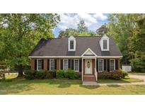 Charming brick home with a well-manicured lawn and classic black shutters at 160 Fox Run Rd, Youngsville, NC 27596