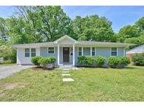 Charming one-story home with a well-manicured lawn and mature trees creating a welcoming curb appeal at 1708 S Alston Ave, Durham, NC 27707