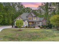 Beautiful home with a mix of stone and siding, complemented by a well-manicured front lawn at 1710 Eddy Ct, Franklinton, NC 27525