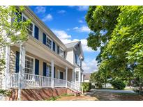 Charming two-story home featuring a welcoming front porch and blue shutters at 206 Wagon Trail Dr, Cary, NC 27513