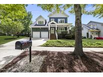 Charming two-story home with a well-maintained front yard and a two-car garage at 209 Brookberry Rd, Holly Springs, NC 27540