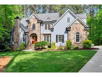 Elegant two-story home boasting stone accents, manicured lawn, and inviting curb appeal at 2201 Avinshire Pl, Wake Forest, NC 27587