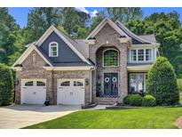 Beautiful two-story brick home featuring a three-car garage and well-maintained landscaping at 2637 Forestbluff Dr, Fuquay Varina, NC 27526
