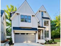 New construction with a two-car garage and craftsman-style accents with a modern design and black trim windows at 3004 Eden Harbor Ct, Raleigh, NC 27613