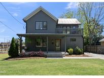 Charming two-story home featuring a gray exterior, covered porch, and well-manicured lawn at 310 Georgetown Rd, Raleigh, NC 27608