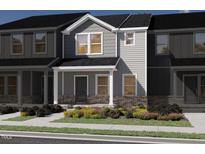 Charming townhome featuring gray siding, brick accents, and a welcoming front porch in a vibrant community at 3703 Rosebush Dr, Zebulon, NC 27597
