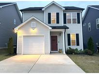 Charming two-story home featuring a driveway, garage, and a welcoming front entrance at 39 Principal Way, Clayton, NC 27520