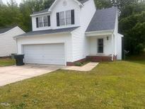 Charming home featuring an attached two-car garage and a well-maintained front yard at 3929 Grandover Dr, Raleigh, NC 27610